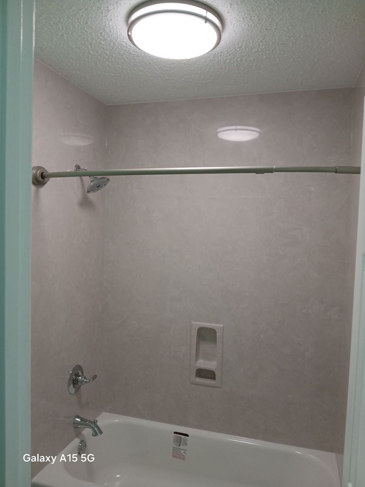 Clean shower and tub surround — fresh gray textured wall